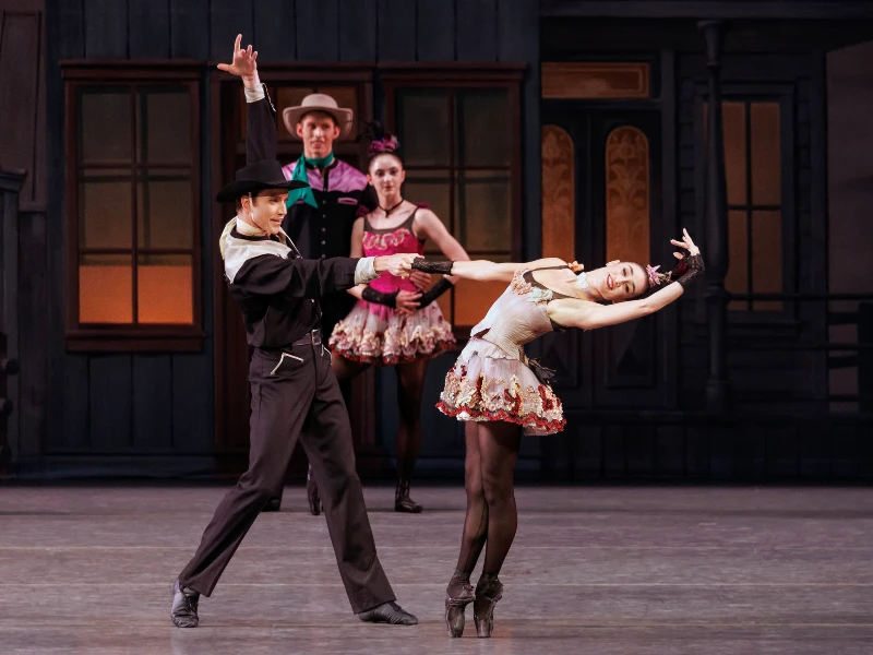 NYCB's Alexa Maxwell in a sage green short dress and Alec Knight dressed like a cowboy in George Balanchine’s Western Symphony. Photo by Erin Baiano.