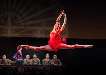 Philadelphia Ballet Carmen and Boléro Review 2025 featuring Mayara Piñeiro as the title character in a split leap wearing a red dress.