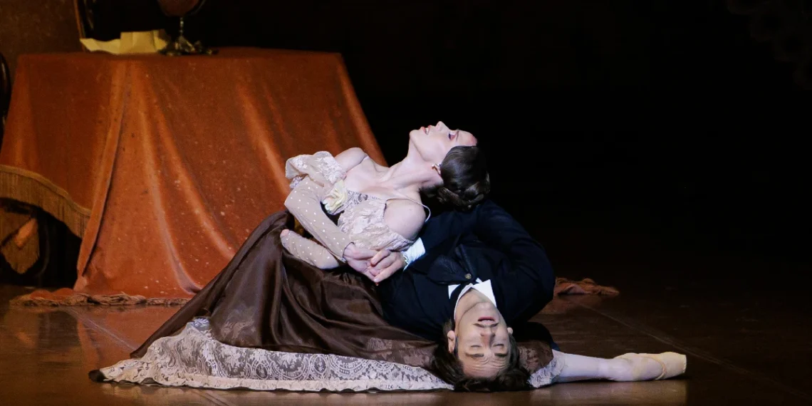 The Stuttgart Ballet Onegin Review 2025 featuring Elisa Badenes and Fiedemann Vogel as Tatiana and Onegin posed on the floor.