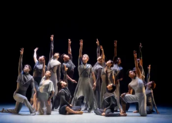 BalletX 20th Anniversary Retrospective Review featuring the company in futuristic silver costumes arms lifted, gaze following above.