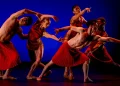 BalletX New Voices Review featuring five dancers in red pleated skirts.